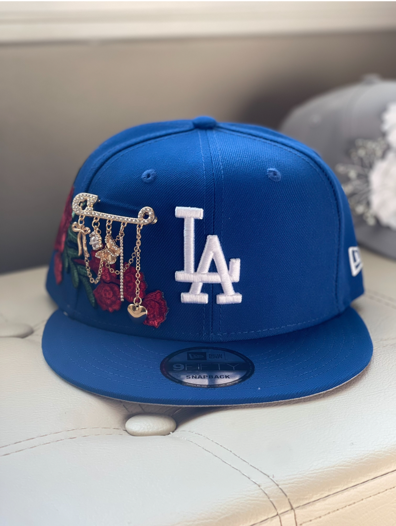 Royal blue LA snapback with rose patches and gold brooch chain